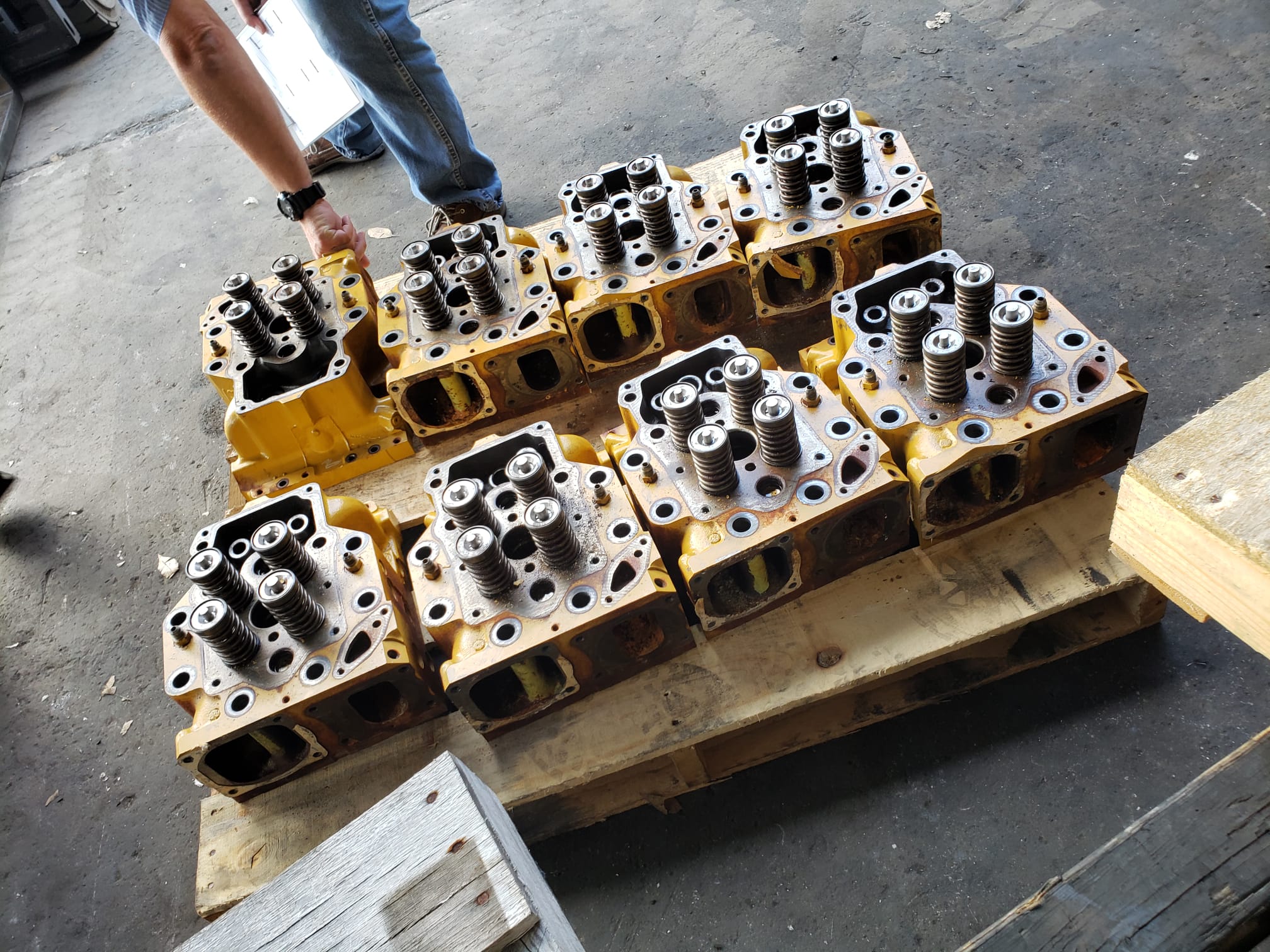 Technician pressure testing a diesel cylinder head for cylinder head repair in South Florida at Motor Service Group.