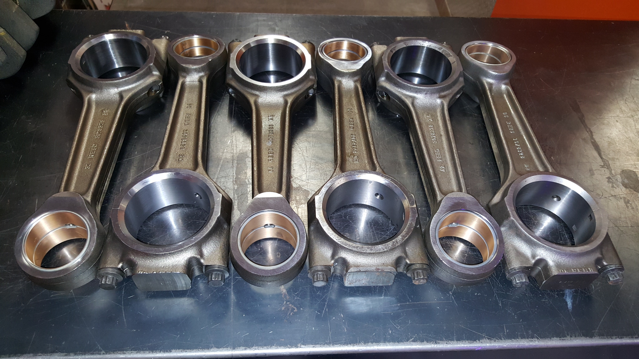 Technician performing connecting rod polishing and repair at Motor Service Group diesel machine shop in Miami