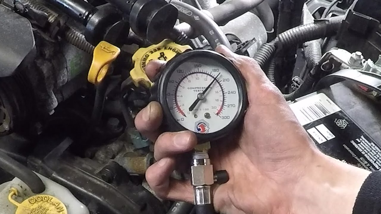 Technician pressure testing a diesel engine cylinder head at a machine shop in Miami before reassembly