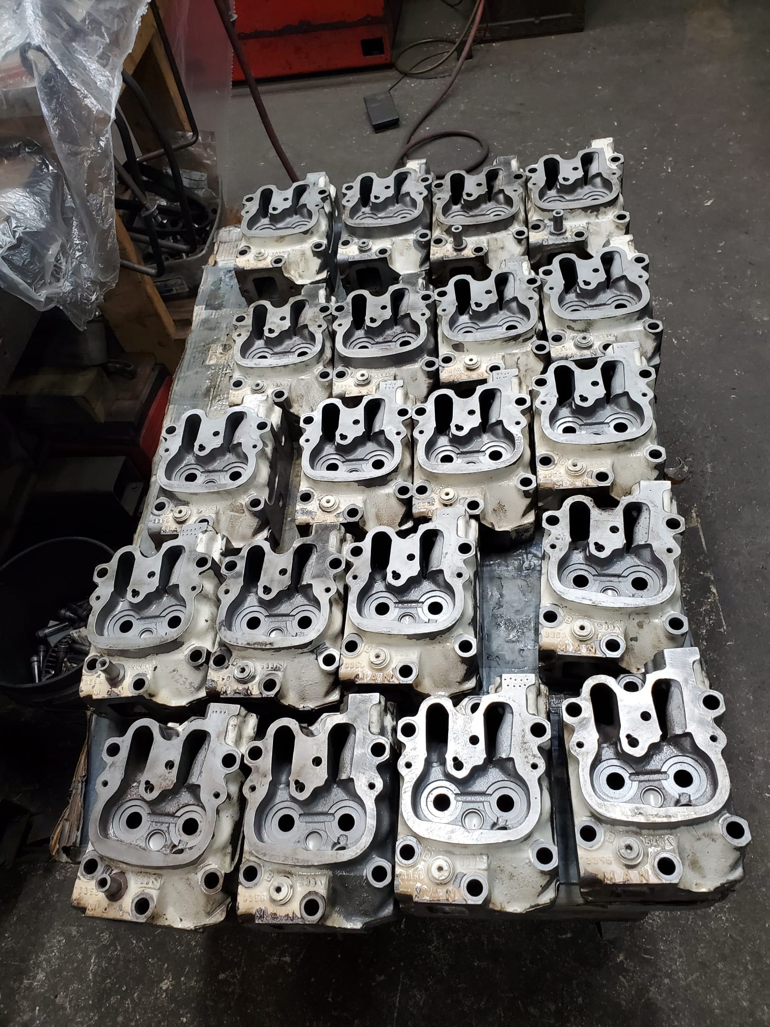 Diesel cylinder head undergoing three-stage magnaflux crack detection and pressure testing at Motor Service Group machine shop in Miami FL