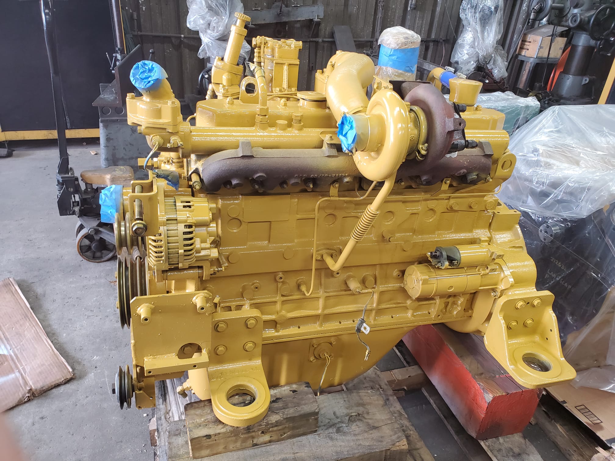 Heavy-duty diesel truck engine on a machine shop bench during precision repair in Miami